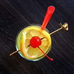 Image showing Cocktail glass decorated with lemon and cherry