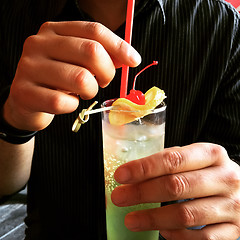 Image showing Man holding a glass with cocktail