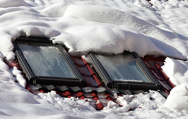 Image showing Snowy roof with icy windows