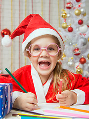 Image showing Girl smiling happily drawing Gift card as a gift for Christmas