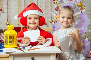 Image showing Makeshift Santa Claus and fairy prepare congratulatory letters