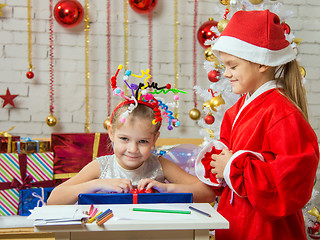 Image showing Santa Claus has presented a gift of a happy girl with fireworks on the head