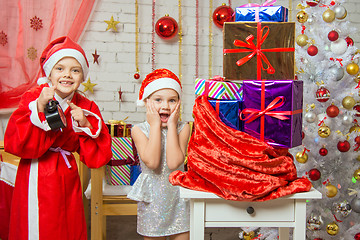 Image showing Santa Claus showed the clock Assistant, all the fun smile