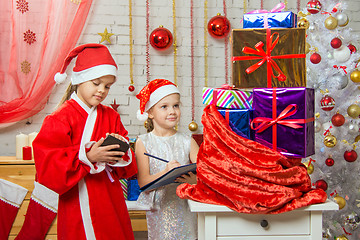 Image showing Santa and helper checked bag with gifts