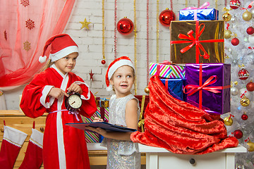 Image showing Santa Claus shows that the assistants time to deliver Christmas gifts