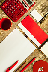 Image showing The mockup on wooden background with red calculator