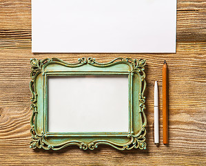 Image showing The mockup on wooden background with vintage old picture frame