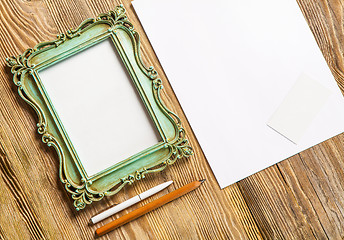 Image showing The mockup on wooden background with vintage old picture frame