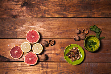 Image showing Lemon and walnut on a wooden surface close up