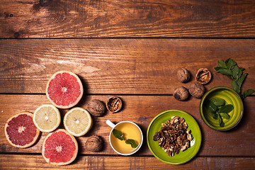 Image showing Lemon and walnut on a wooden surface close up