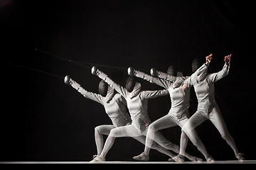 Image showing Full-length portrait of woman wearing white fencing costume  on black 