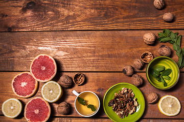 Image showing Lemon and walnut on a wooden surface close up