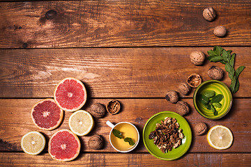 Image showing Lemon and walnut on a wooden surface close up