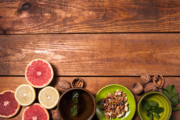 Image showing Lemon and walnut on a wooden surface close up