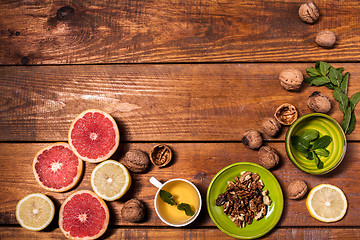 Image showing Lemon and walnut on a wooden surface close up