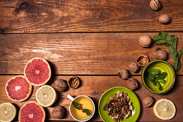 Image showing Lemon and walnut on a wooden surface close up