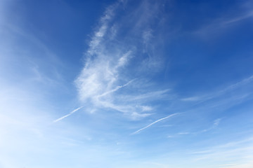 Image showing Amazing cloudscape with airplanes tracks