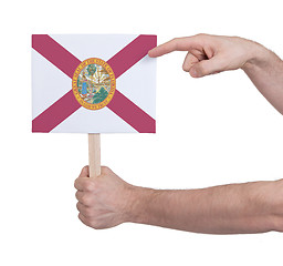 Image showing Hand holding small card - Flag of Florida