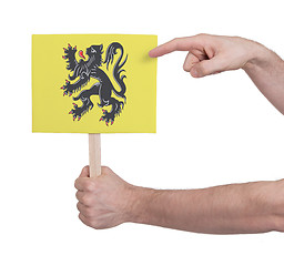 Image showing Hand holding small card - Flag of Flanders
