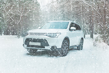 Image showing Winter driving. Off-road riding on winter forest snowy road