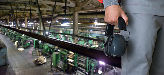 Image showing Worker with protective headphone