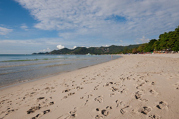 Image showing Beach on tropical island. Clear blue water, sand, clouds. 