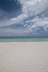 Image showing Beach on tropical island. Clear blue water, sand, clouds. 