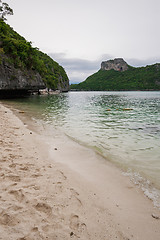 Image showing Beach on tropical island. Clear blue water, sand, clouds. 