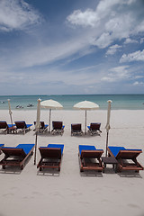 Image showing Beach on tropical island. Clear blue water, sand, clouds. 