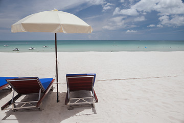 Image showing Beach on tropical island. Clear blue water, sand, clouds. 