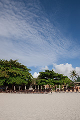 Image showing Beach on tropical island. Clear sand, clouds. 