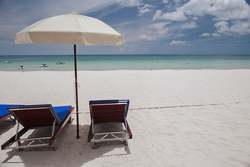 Image showing Beach on tropical island. Clear blue water, sand, clouds. 