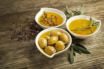 Image showing Olive oil with herbs