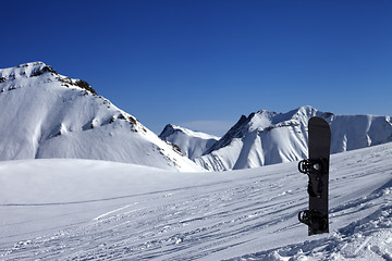 Image showing Snowboard in snow on off-piste slope