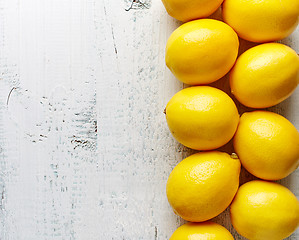 Image showing fresh ripe lemons on wooden table