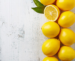 Image showing fresh ripe lemons on wooden table