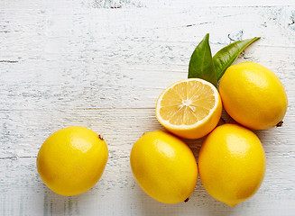 Image showing fresh ripe lemons on wooden table