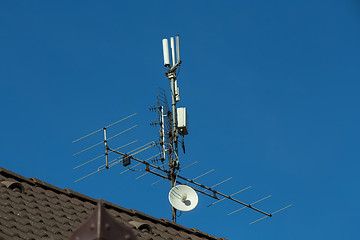 Image showing television antenna and wi-fi transmitter on the roof