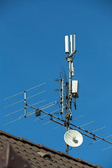 Image showing television antenna and wi-fi transmitter on the roof