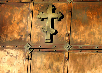 Image showing The copper cross on the gate 