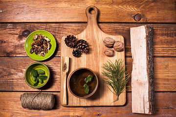 Image showing Still life with walnuts on a wooden board