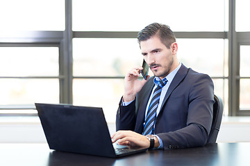 Image showing Businessman in office working on laptop computer.