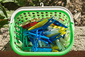 Image showing colored plastic clothespins in a basket