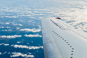 Image showing Passenger Plane flies over clouds