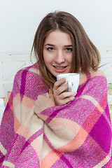 Image showing Sick woman covered with blanket holding cup of tea