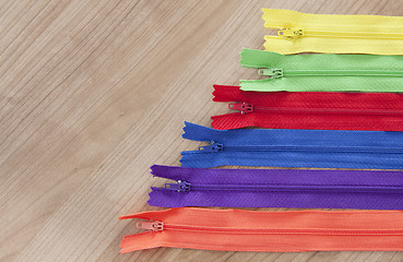 Image showing Zippers wooden background