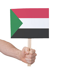 Image showing Hand holding small card - Flag of Sudan