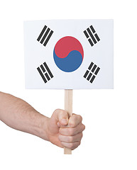 Image showing Hand holding small card - Flag of South Korea