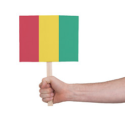 Image showing Hand holding small card - Flag of Guinea