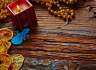 Image showing Seasonal rustic Christmas border composed of ornaments over a wooden background with copyspace, overhead view